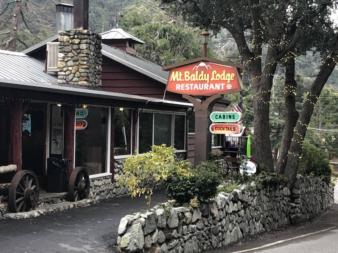 The Mt Baldy Lodge restaurant sign and stone chimney