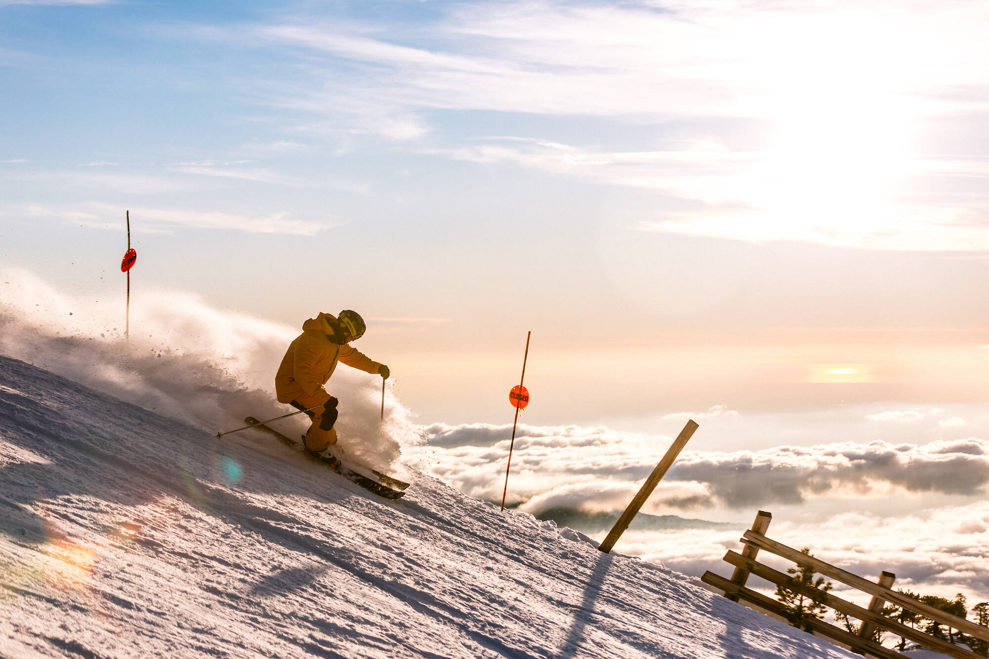 A skier carving fresh snow above a sea of clouds on Mt Baldy